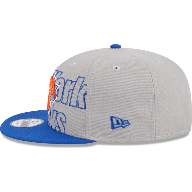 graue-und-blaue-flatcap-snapback-9fifty-draft-edition-2023-der-new-york-knicks-nba-von-new-era